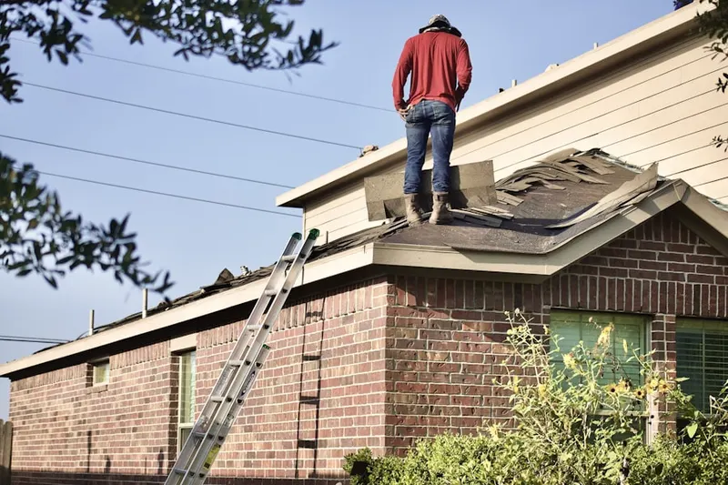Professional roofer working on a residential roof in Fairlawn